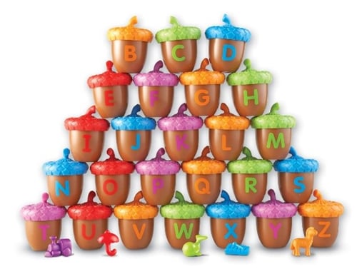 A group of acorns with letters of the alphabet on each acorn toy. 